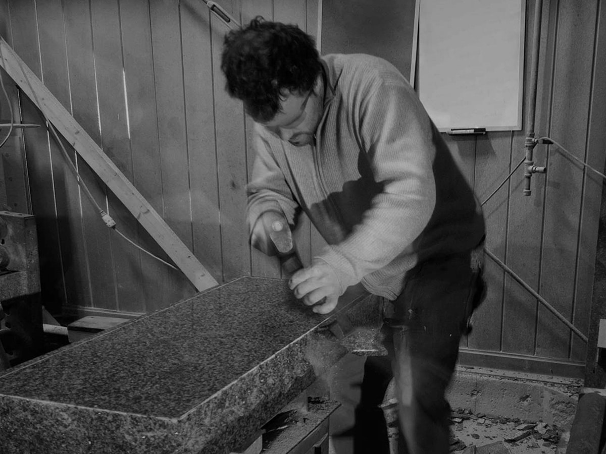 Image of a man working with granite