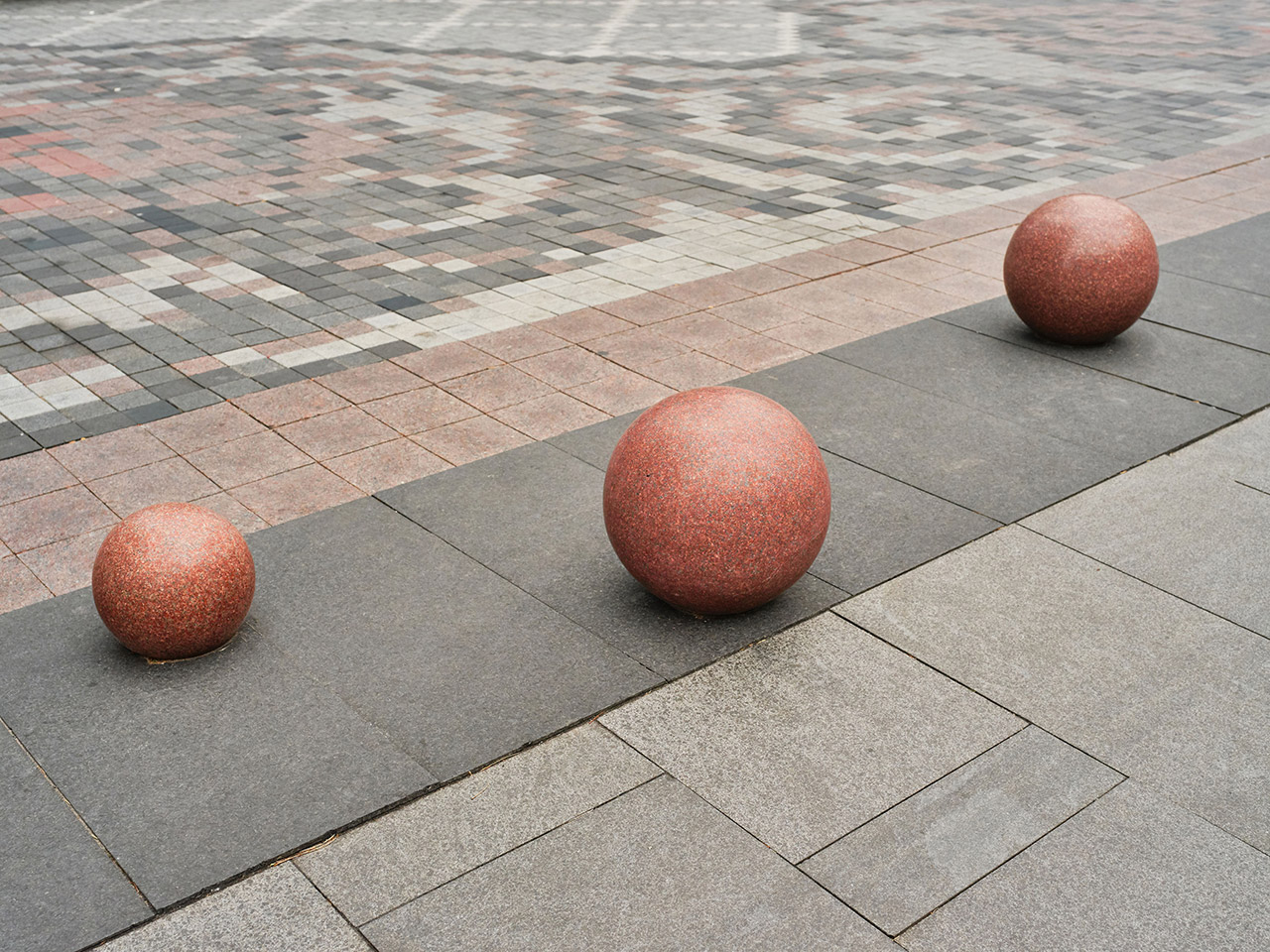 3 brownish granite spheres placed on plaza outside the four seasons hotel in Ontario Canada