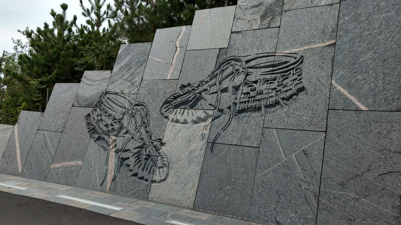 Close-up view at the intricate patterns and craftsmanship on the granite block wall created by HGH Granite