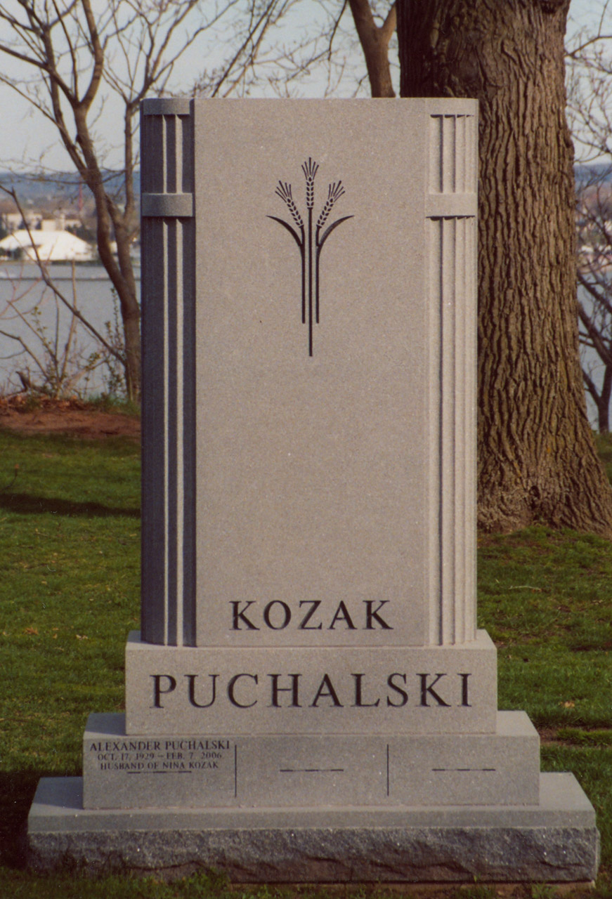 Kozak Puchalski granite headstone monument by HGH Granite located in a public setting