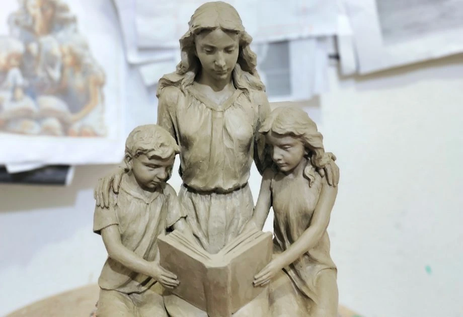 Clay sculpture of mother and children front