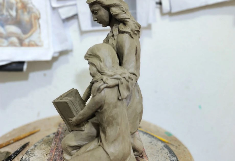 Clay sculpture of mother and children side