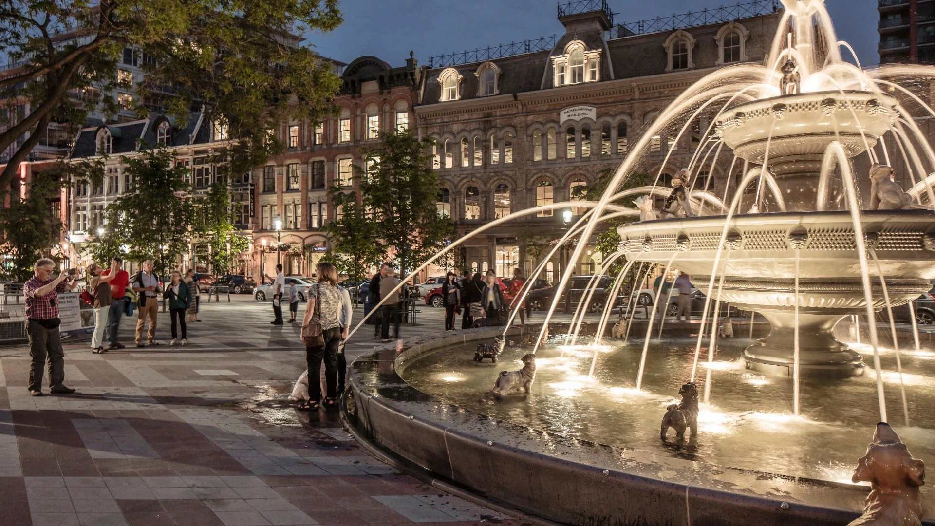 Berczy Park at night - a big granite water fountain in a public area lit up