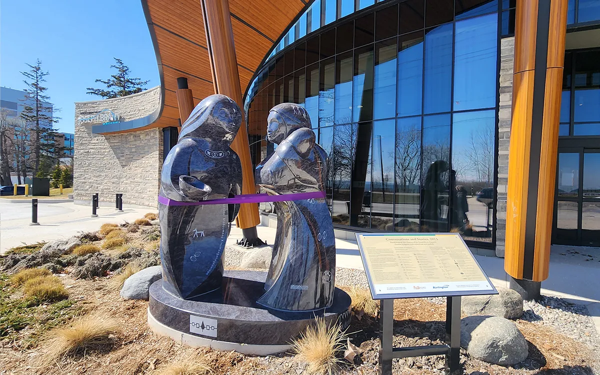 This sculpture for the Joseph Brant Museum in Burlington, features two women on their way to visit the museum, one carrying her granddaughter.